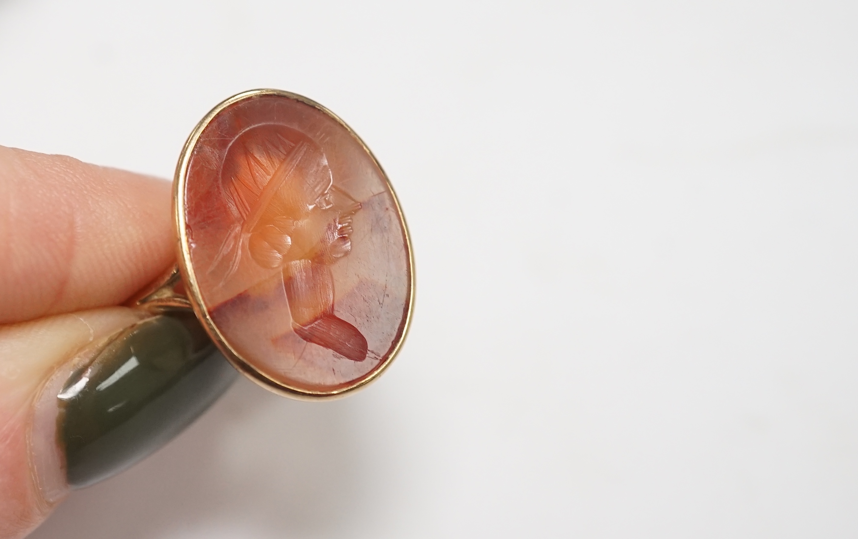 A yellow metal and intaglio agate set oval ring, size P, together with a modern 18ct gold signet ring, engraved with a bird, gross weight 12.3 grams. Condition - poor to fair